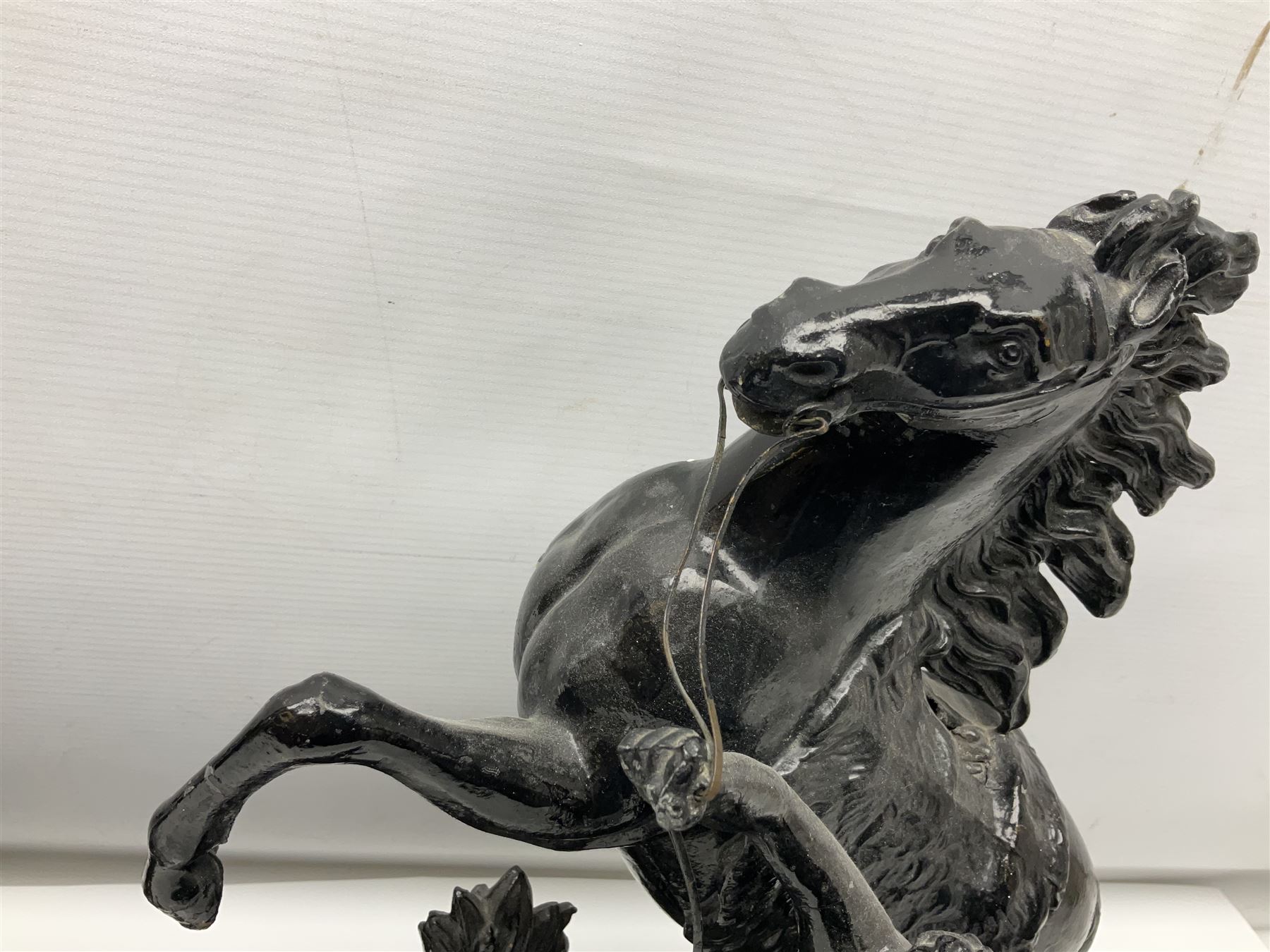 Pair of spelter figural statues of man and rearing horse, height 44cm and 42cm