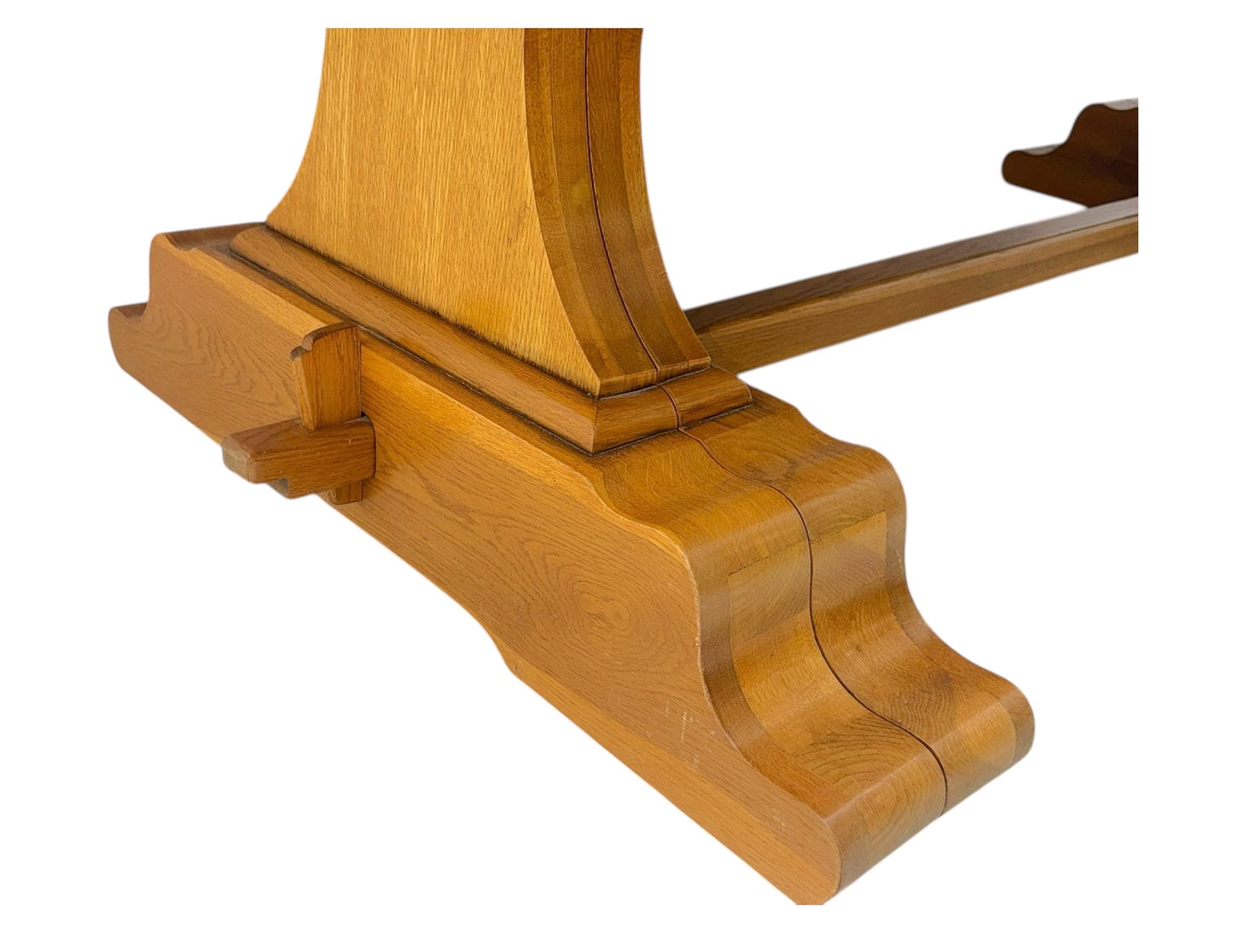 Oak extending dining table with elegant scrolled shaped double pedestal base and scrolled feet; together with a set of eight ladder back chairs with rush seats ((9) table closed 228x95x79cm chairs 106x38x44cm 