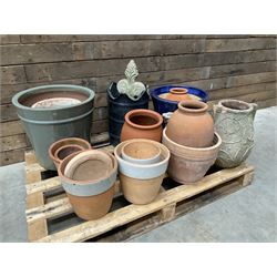 A quantity of various terracotta and glazed planters