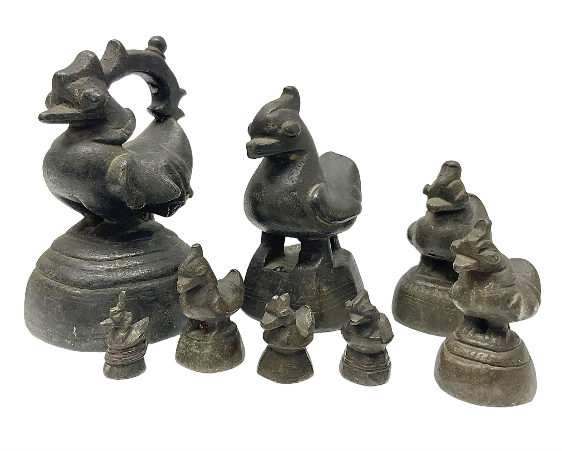 19th century graduating set of Burmese bronze opium weights, in the form of Hintha birds, tallest H11.5cm (8)