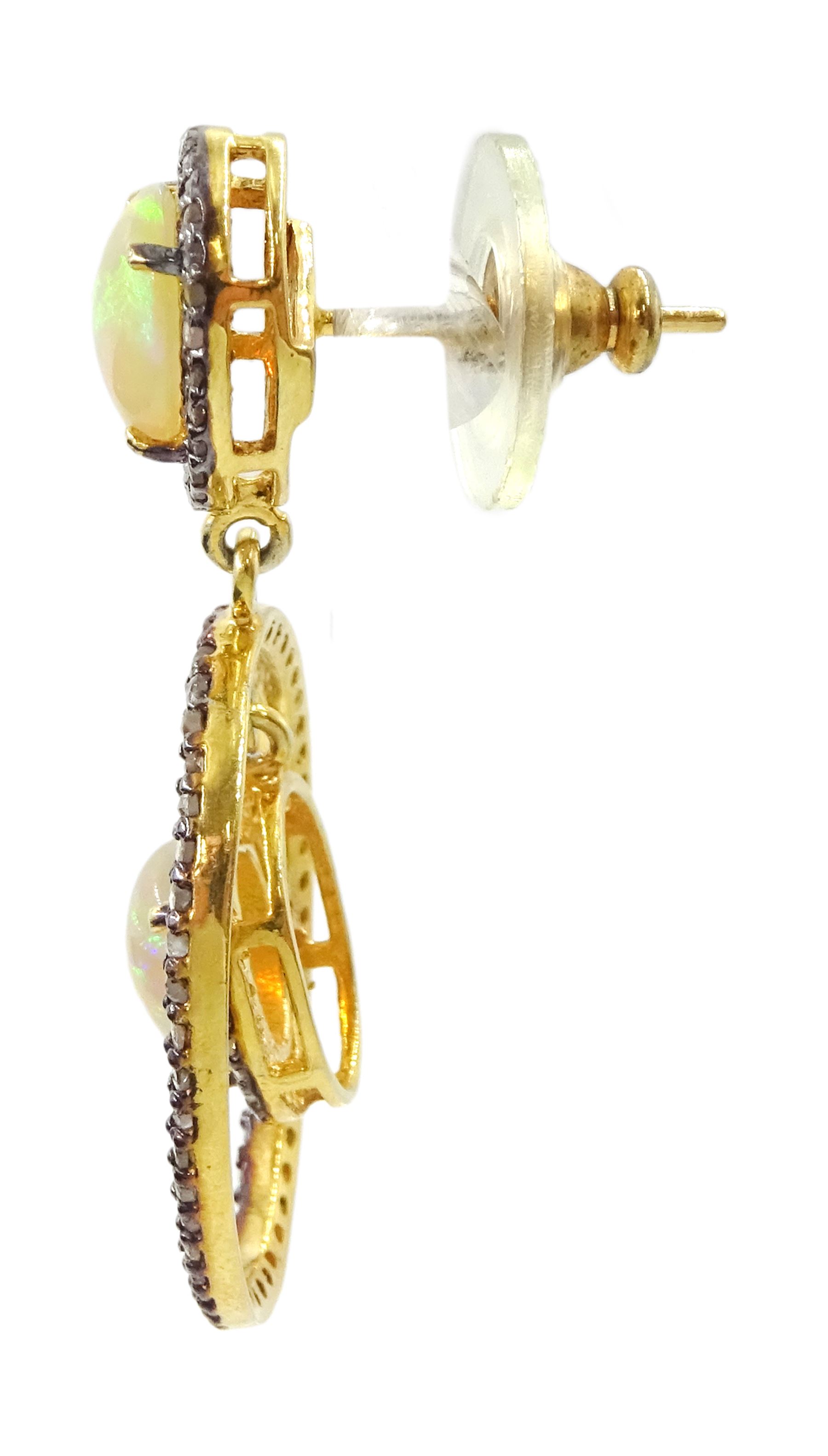 Pair of silver and gold, opal and diamond pendant stud earrings, opal and diamond cluster, suspending a further opal with diamond set surround