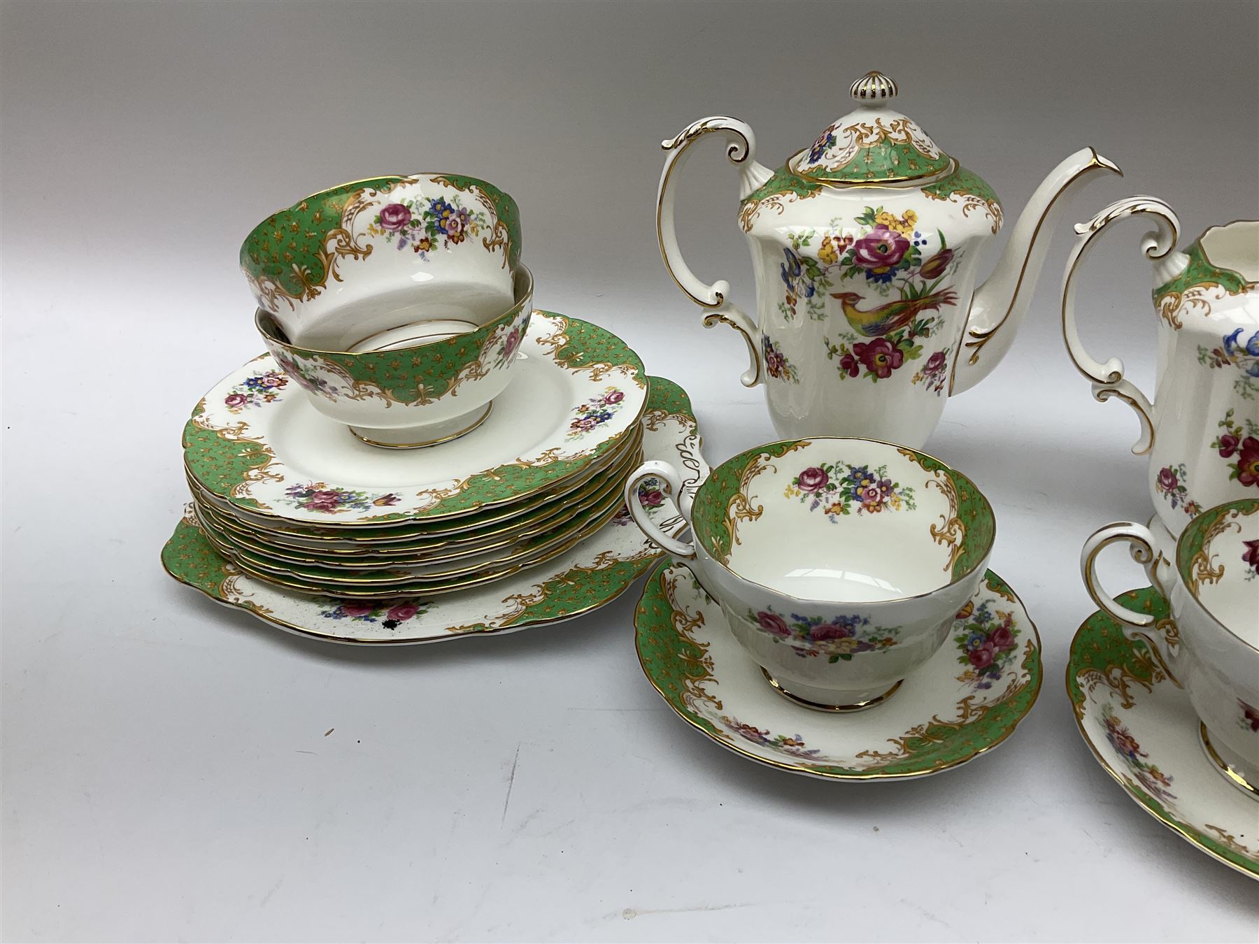 Paragon Rockingham pattern tea set, comprising teapot, coffee pot, four teacups and four saucers, six side plates, six dessert plates, cake plate, two open sucriers, and jug. 