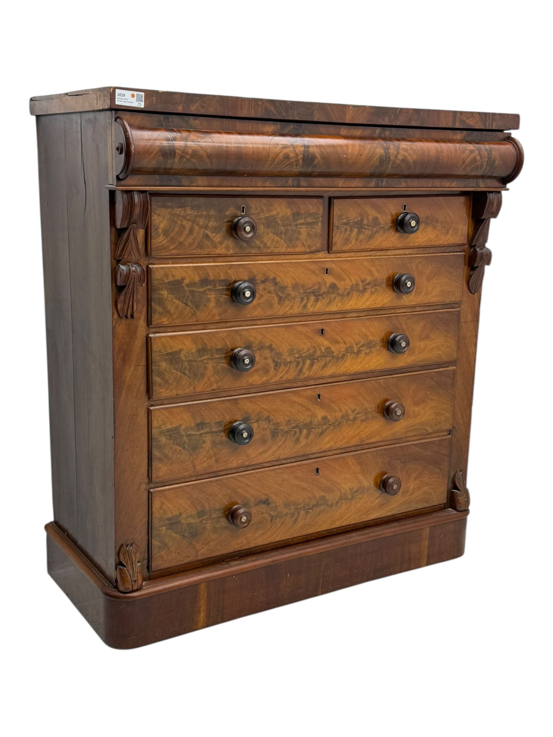 19th century flame mahogany Scotch chest, frieze long drawer above two short and four long graduating drawers, with turned knobs scrolled carved side bracket 