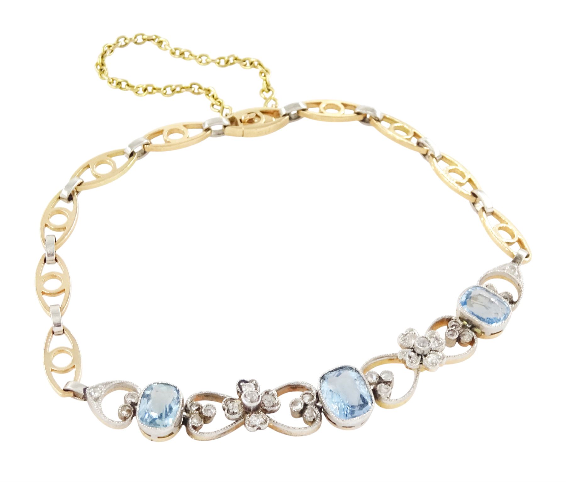Early 20th century gold and platinum aquamarine and diamond bracelet, three cushion cut aquamarines, each spaced by milgrain set diamond heart and flower head links, to a fancy gold and platinum openwork link bracelet