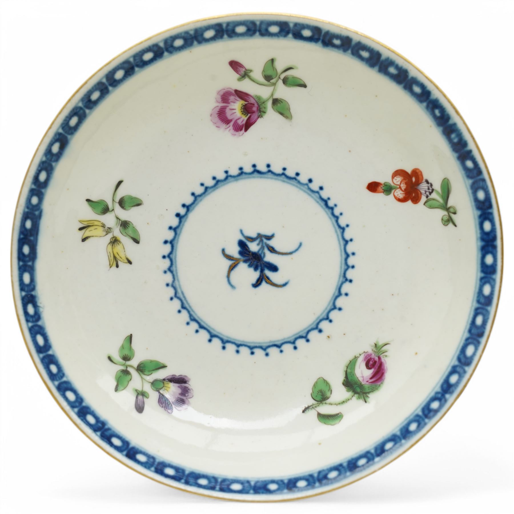 Worcester tea bowl and saucer, c.1770, painted with polychromatic floral sprays within blue borders, bearing crescent marks to base, with another similar early example, unmarked