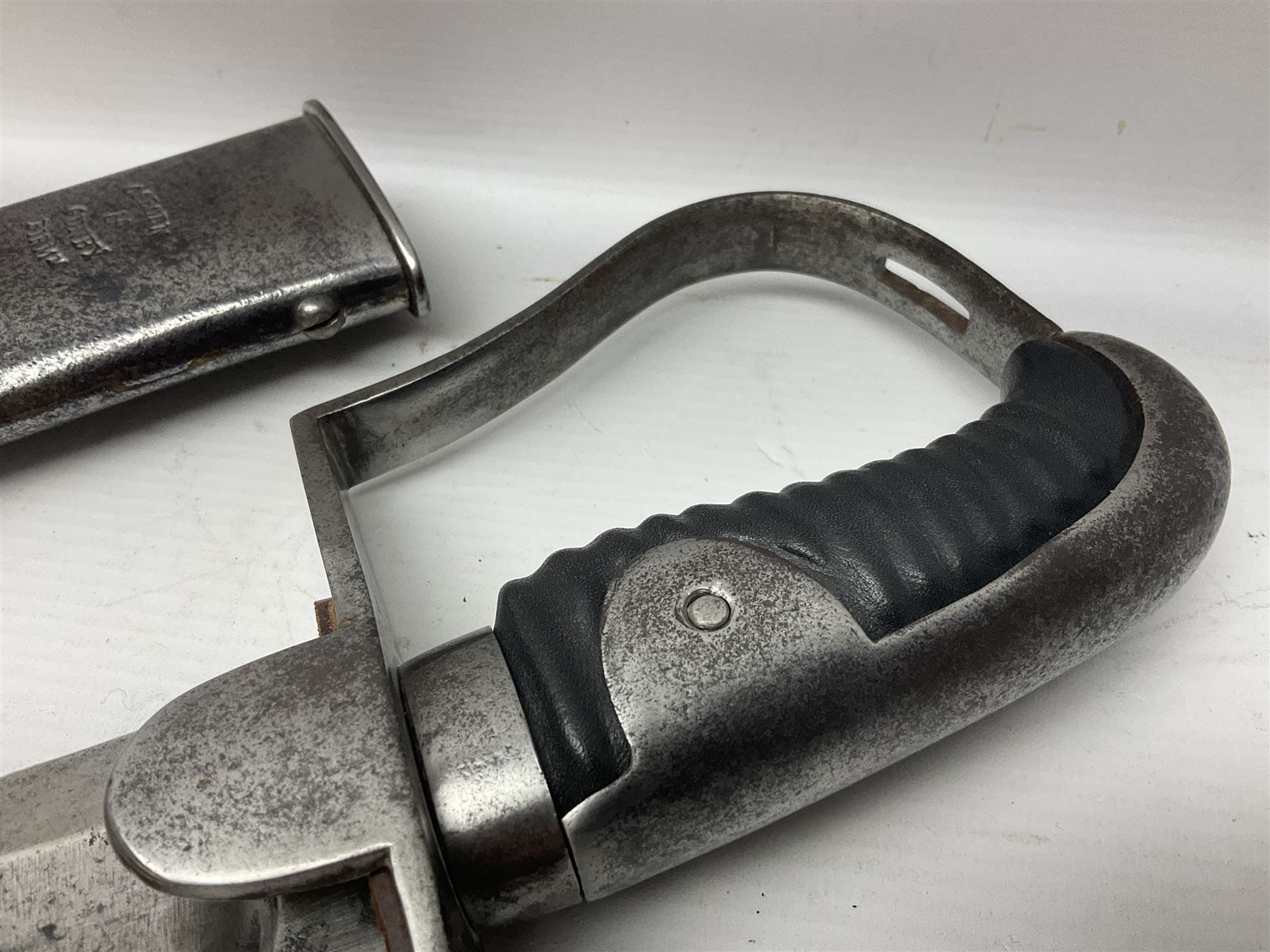 British 1796 Pattern Light Cavalry trooper's sword, the 84cm curving fullered blade stamped Hadley.1 to the back edge, steel hilt with knucklebow, D-shaped langets and leather grip; in polished steel scabbard stamped Osborn & Gunby Birmm. and W.R.16 ( ?16th Light Dragoons) with two suspension rings L100cm overall