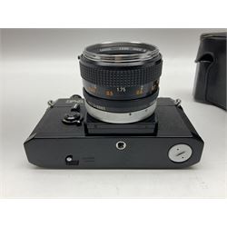 Canon F1n camera body, serial no. 572972, with 'Canon FD 50mm 1:1.4' lens, serial no. 246665, with leather case 