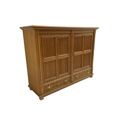 Continental 20th century carved oak cabinet, dentil frieze over two panelled doors with fluted facias, over two drawers