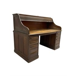 Cutler - early 20th century American oak tambour roll-top desk, the twin pedestals fitted with four graduating drawers