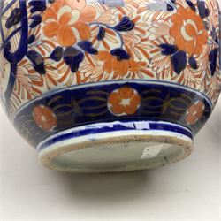 Pair of large 19th century Japanese Imari porcelain bottle vases, painted with shaped reserves of peonies, chrysanthemums and prunus blossom, each H46cm