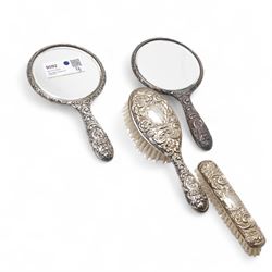 Pair of silver backed hand mirrors, clothes brush and hair brush (4)
