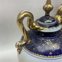19th century Vienna style porcelain 'Musik' garniture, the central vase of baluster form with domed cover flanked by two smaller vases with twin curved gilt handles to short neck, each decorated with classical figural vignettes between blue borders heightened with gilt, H33.5cm