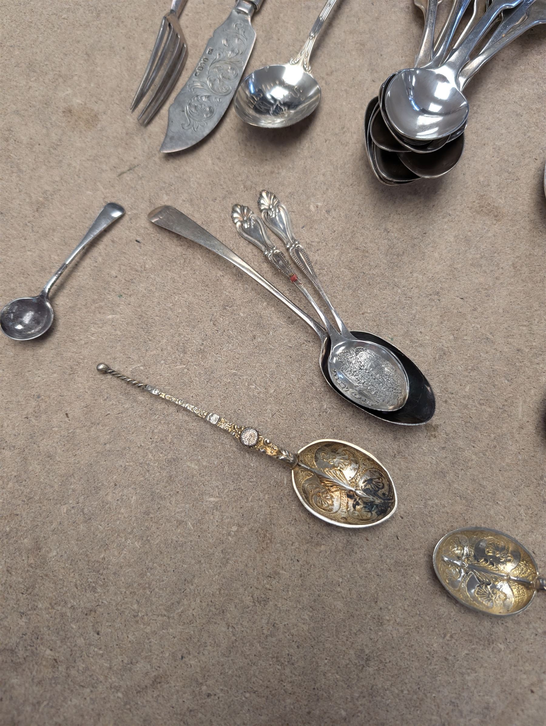 Collection of silver teaspoons, including souvenir and American silver examples, together with a silver handled fork and a mother of pearl handled silver knife, all stamped or hallmarked 