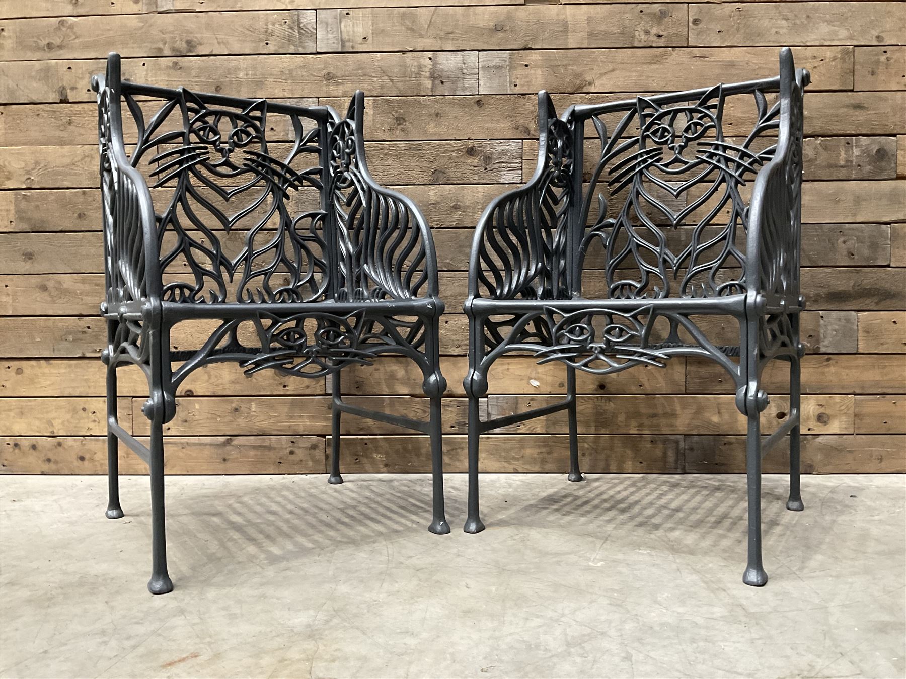 Richard Bawden (1936-2024): Pair of Cat design painted cast iron garden armchairs