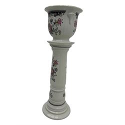 Royal Winton - early 20th century ceramic jardinière on stand, white ground with polychrome floral decoration, flared rim and twin handles, on circular base