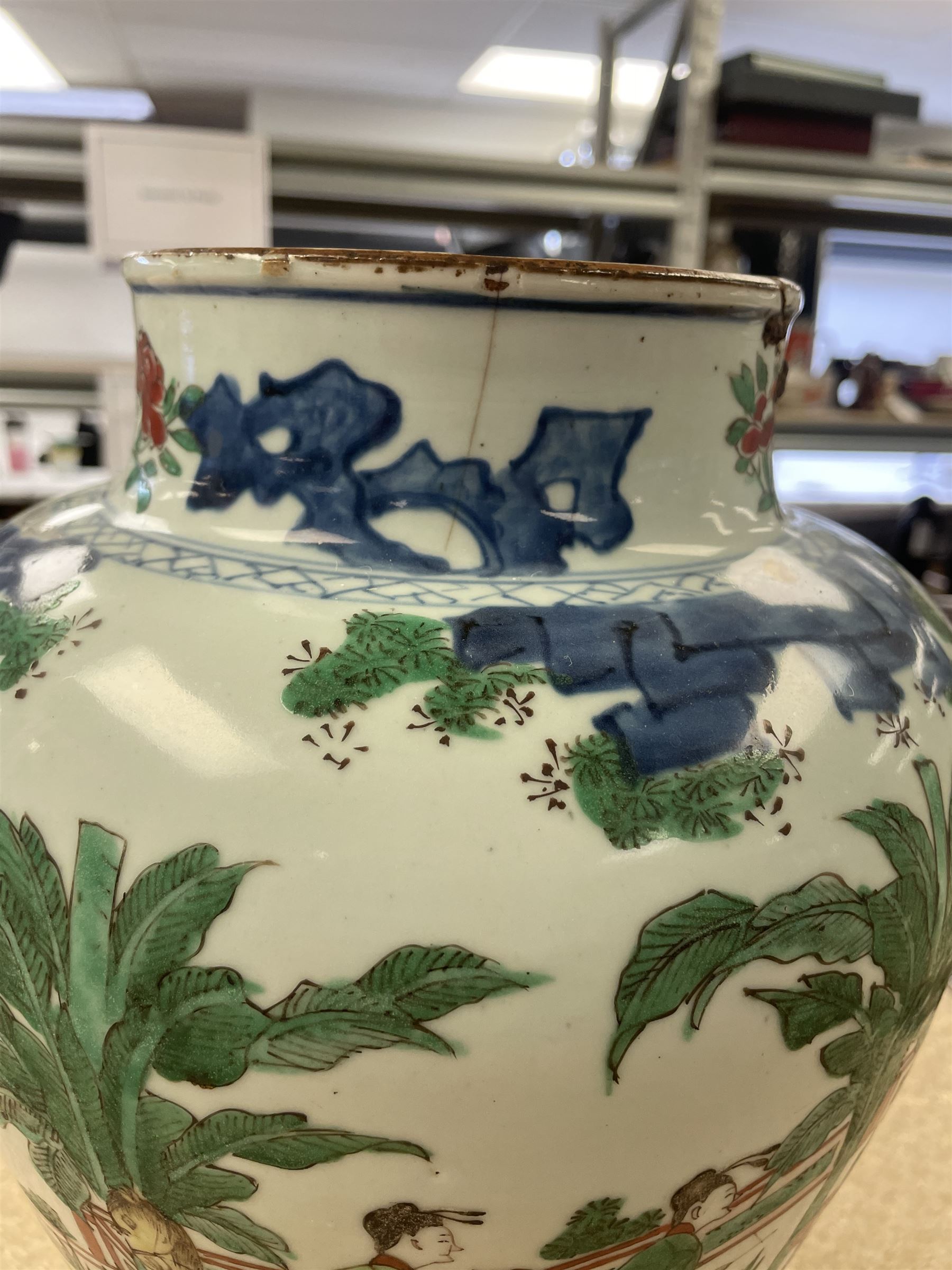 17th century Transitional period Chinese Wucai vase and cover, of baluster form, the body painted with ladies upon a terrace, and figures upon horseback and attendants within a fenced garden, the domed cover with knop finial painted with boys at play, H37cm
