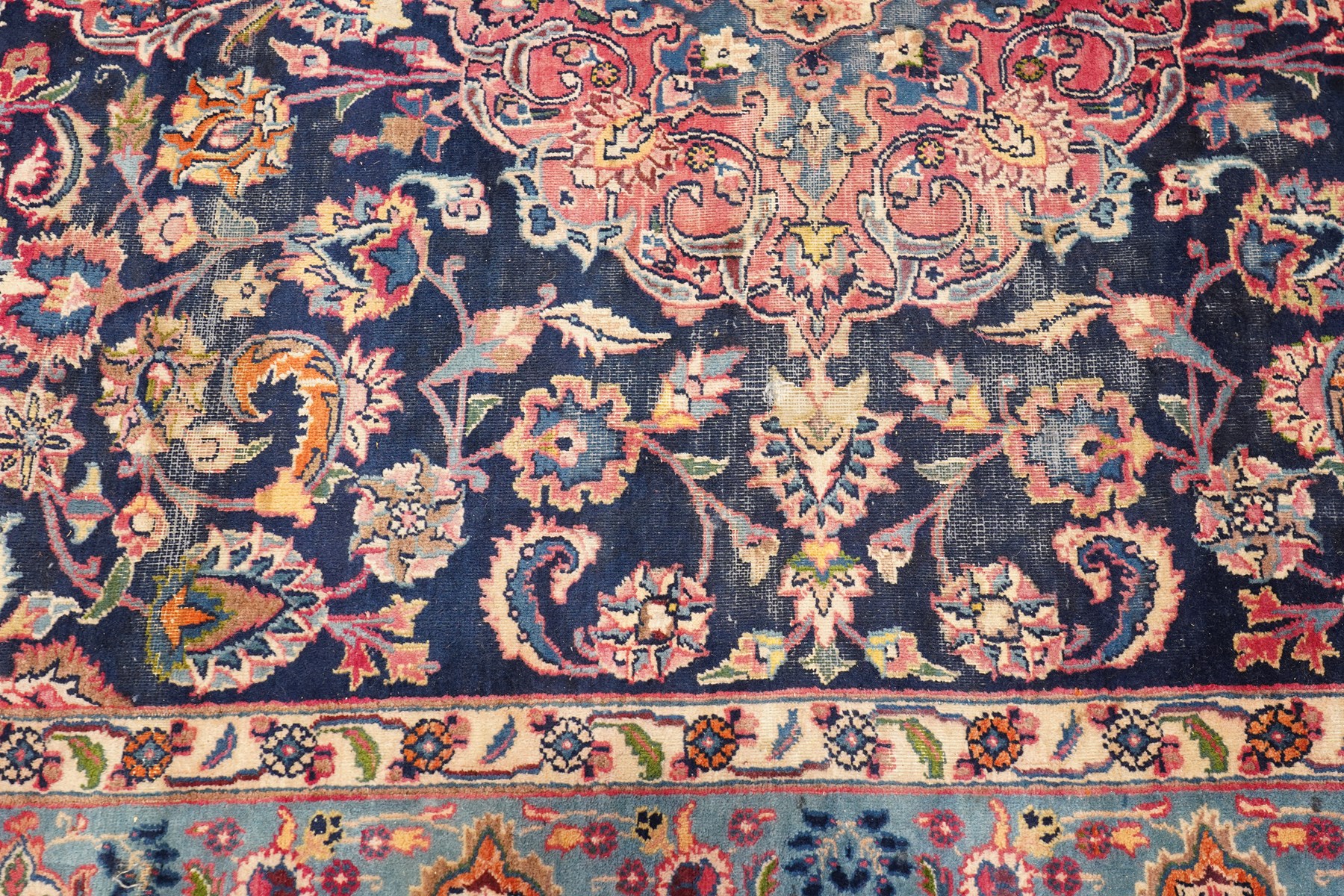 Vintage Persian Tabriz indigo ground rug, the central floral medallion within a field woven with scrolling palmettes and plant motifs, with contrasting spandrels, the the cyan guard lines with scrolling floral patterns
