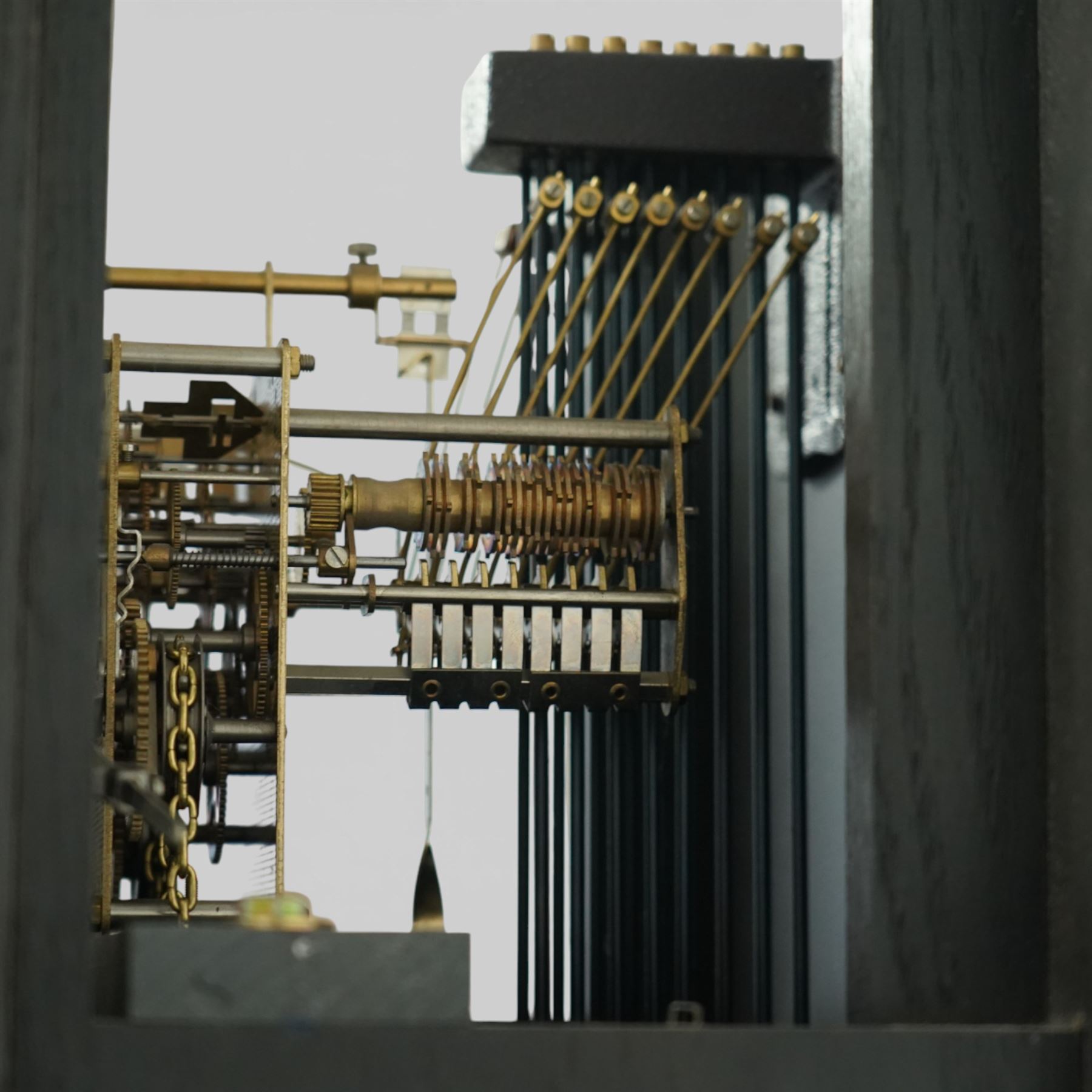 20th century Sligh longcase clock, the painted rectangular case with stepped and moulded hood enclosing a square painted dial with Roman numerals and spade hands, the trunk with single panelled door and moulded plinth base, the eight day weight driven movement with brass plates, chain driven train, anchor escapement and outside countwheel striking mechanism, issuing on a series of tuned rods with pendulum and brass cased weights