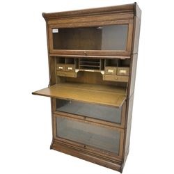 Globe Wernicke design - early 20th century oak four-tier stacking library bookcase, three glazed cabinets with up-and-over doors, fall front compartment with fitted interior 