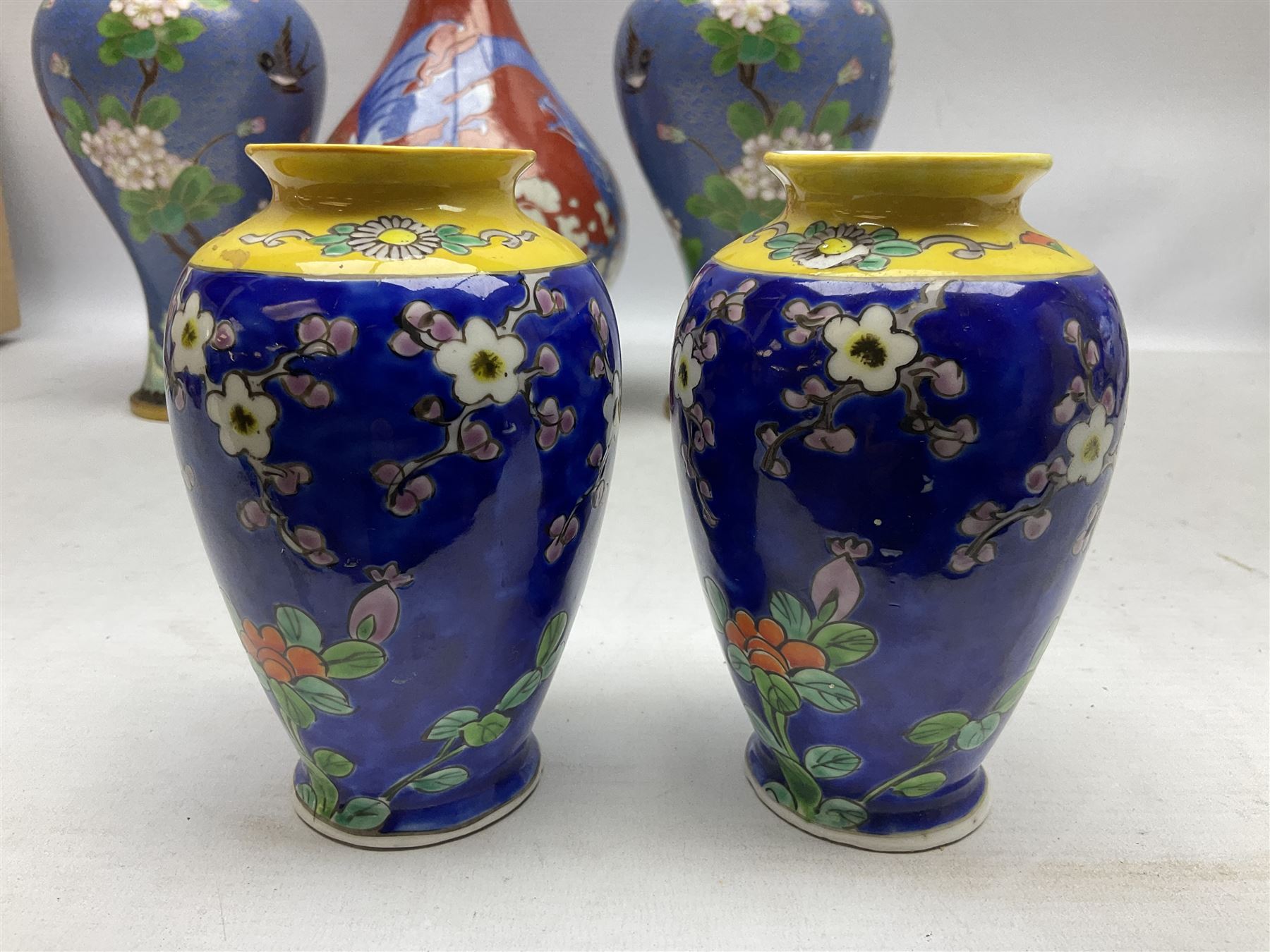 20th Century Japanese vase decorated with a blue dragon and gilding upon red yellow ground, bears Fukagawa Seiji mark (a/f), together with pair of blue cloisonné vases of baluster form decorated with blossom, and pair of Japanese vases, tallest H26cm