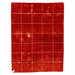 Two contemporary Moroccan Berber hand-woven rugs, deep madder red field of plain design, 199x153cm, other with deep madder red field with a simple lattice of ivory lines forming panels with some tonal variation, 190x146cm 