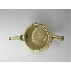 18th century creamware teapot, probably Leeds, with reeded entwined handle and floral finial to the cover, the body with hand painted polychrome decoration of figure to one side, and floral spray to the other, collectors paper label beneath inscribed Leeds Pottery, H11.5cm