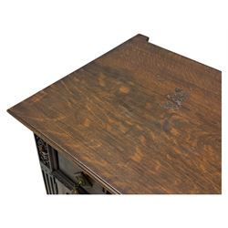 Jacobean-style oak dresser base with two frieze drawers above three cupboards with panelled and moulded decoration, fitted with drop handles, supported on bun feet, circa 1900