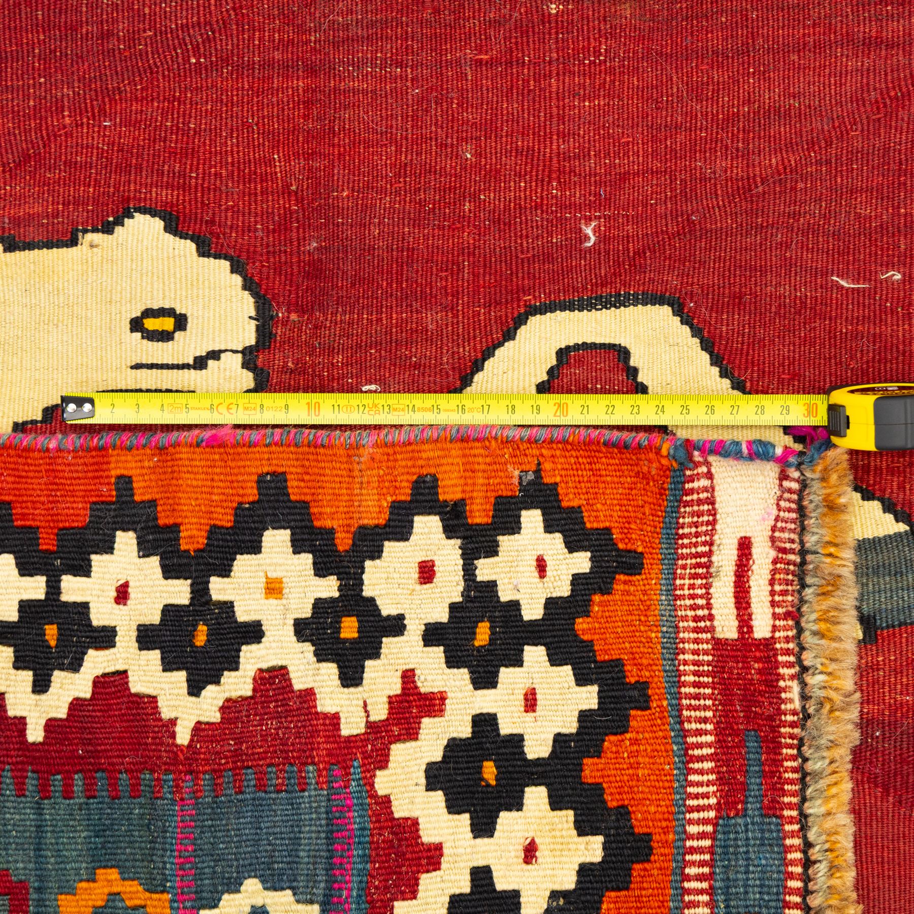 Southwest Persian Qashqai kilim, flatwoven wool with central pictorial design of mirrored horses on a red ground, framed by multicoloured motifs and stepped ivory border, vibrant palette throughout