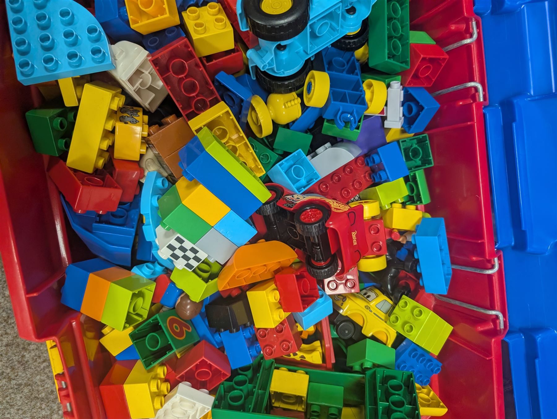 Box of loose Lego Duplo bricks, vehicles and figures