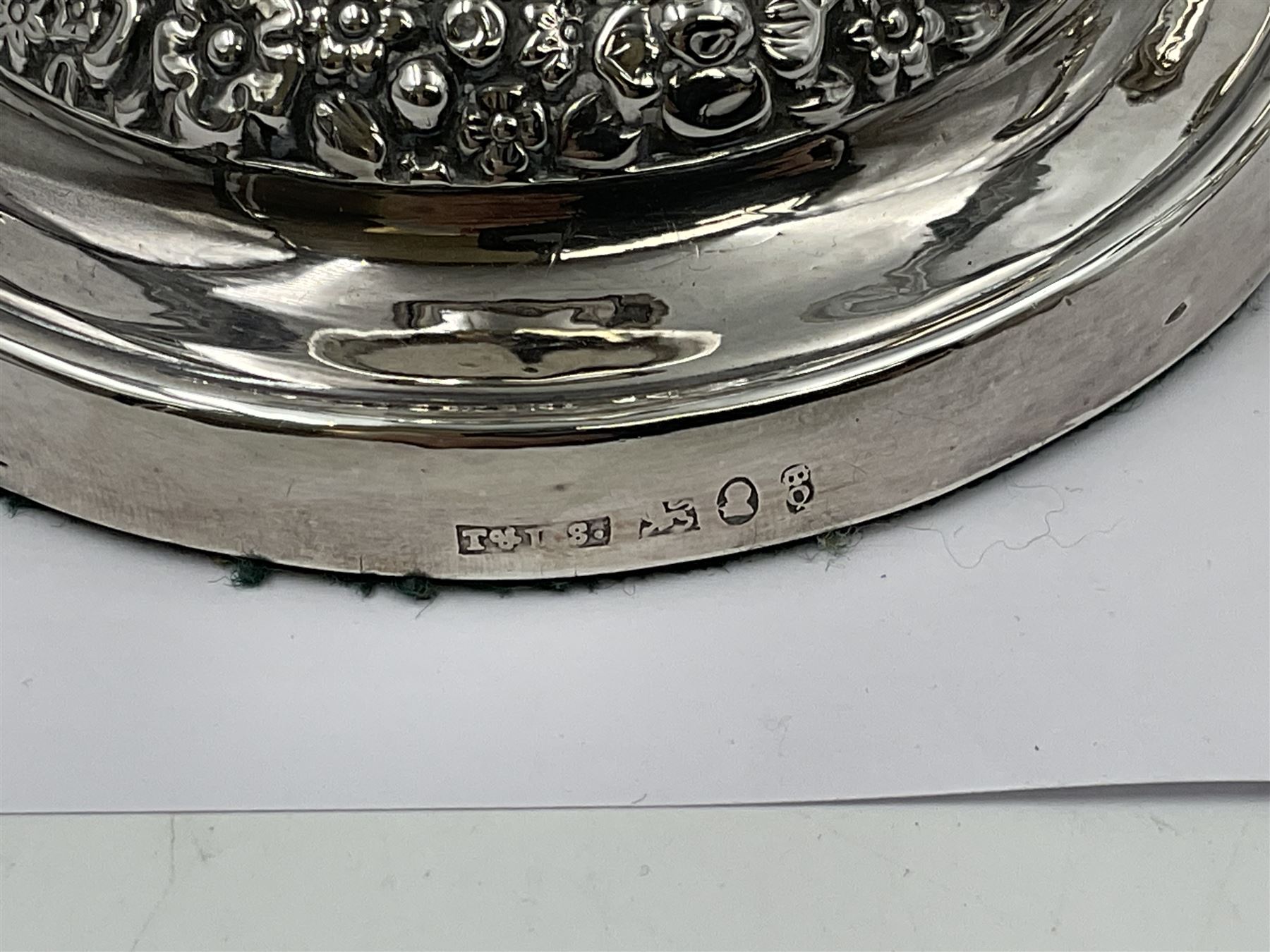 Four George III silver candlesticks, each upon knopped stem and weighted circular stepped foot, the foot and removable sconce repousse decorated with a band of flower heads, hallmarked to sconce and foot Thomas & John Settle, Sheffield 1820, H17.5cm