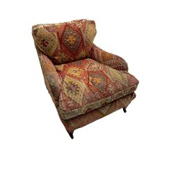 Early 20th century Howard style armchair, upholstered in Kilim fabric with sprung seat, hardwood frame, square tapering supports with brass and ceramic castors