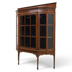 Edwardian inlaid mahogany display cabinet of rectangular canted form, galleried top with crossbanded inlay, above a glazed cabinet enclosing  baize lined shelves, raised on square tapering legs terminating in spade feet  