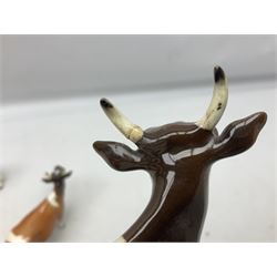 Five Beswick figures of cattle Comprising Ayrshire Bull Ch Whitehill Mandate, no 1454B, three Ayrshire Cow Ch Ickham Bessie, no 1350 and Ayrshire Calf, no 1249B, all with printed marks beneath