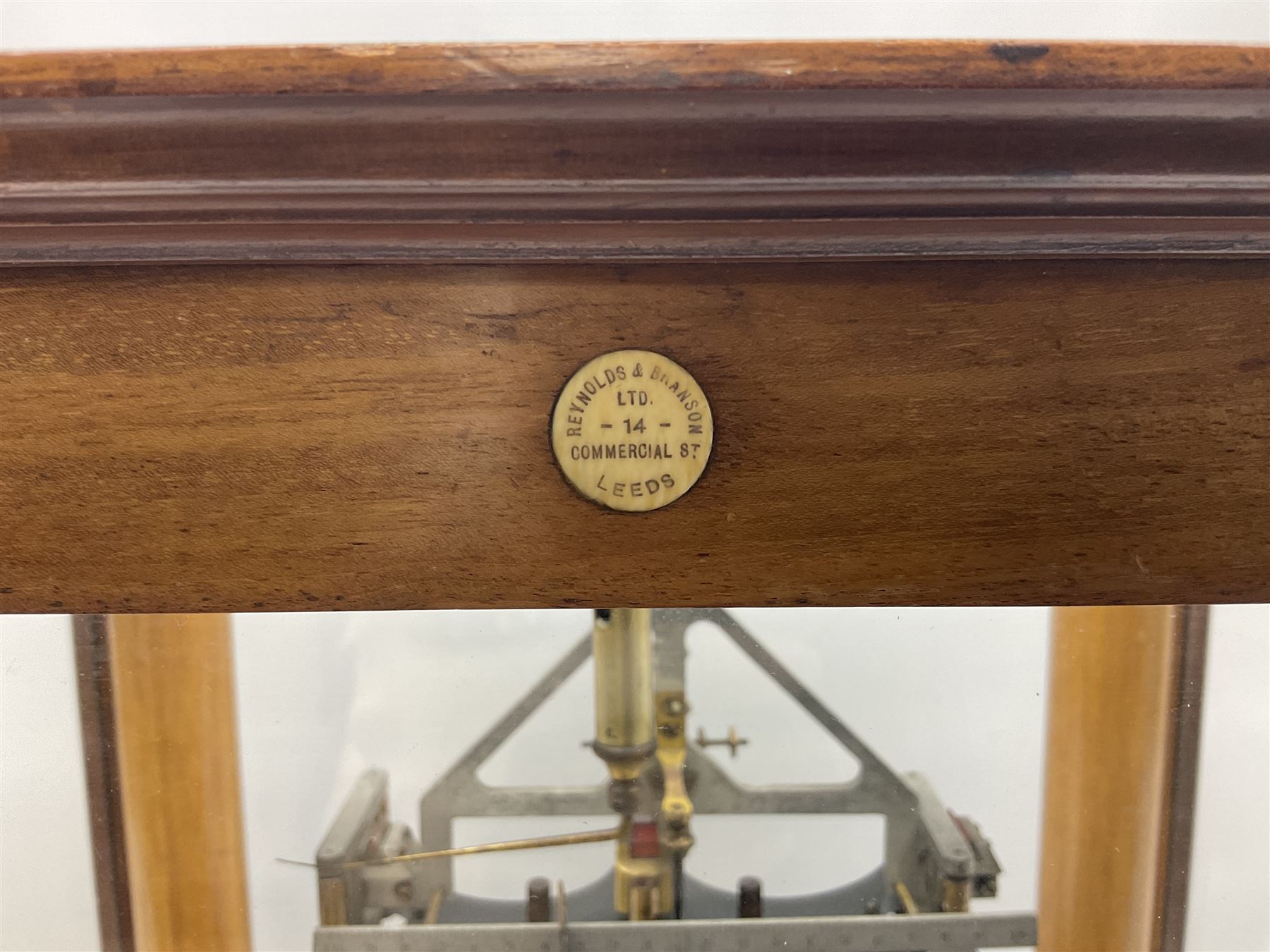 Set of laboratory balance scales by Reynolds & Branson of Leeds in fully glazed mahogany case with rise-and-fall front door, black vitrolite base with brass feet and hand cranked action L40cm H51.5cm D30cm; and bakelite cased set of brass weights