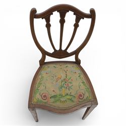 Edwardian pair of satinwood inlaid shield back chairs, the pierced shield shaped backs with central splats inlaid with floral and foliate motifs, tapestry upholstered serpentine seats, raised on square tapering supports