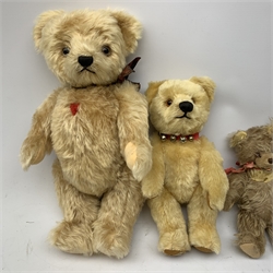  A group of four teddy bears, to include a small Steiff example with button to ear, and a Chad Valley example with label to foot, each with jointed limbs and glass eyes.   