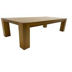 Light oak coffee table, rectangular top over square supports