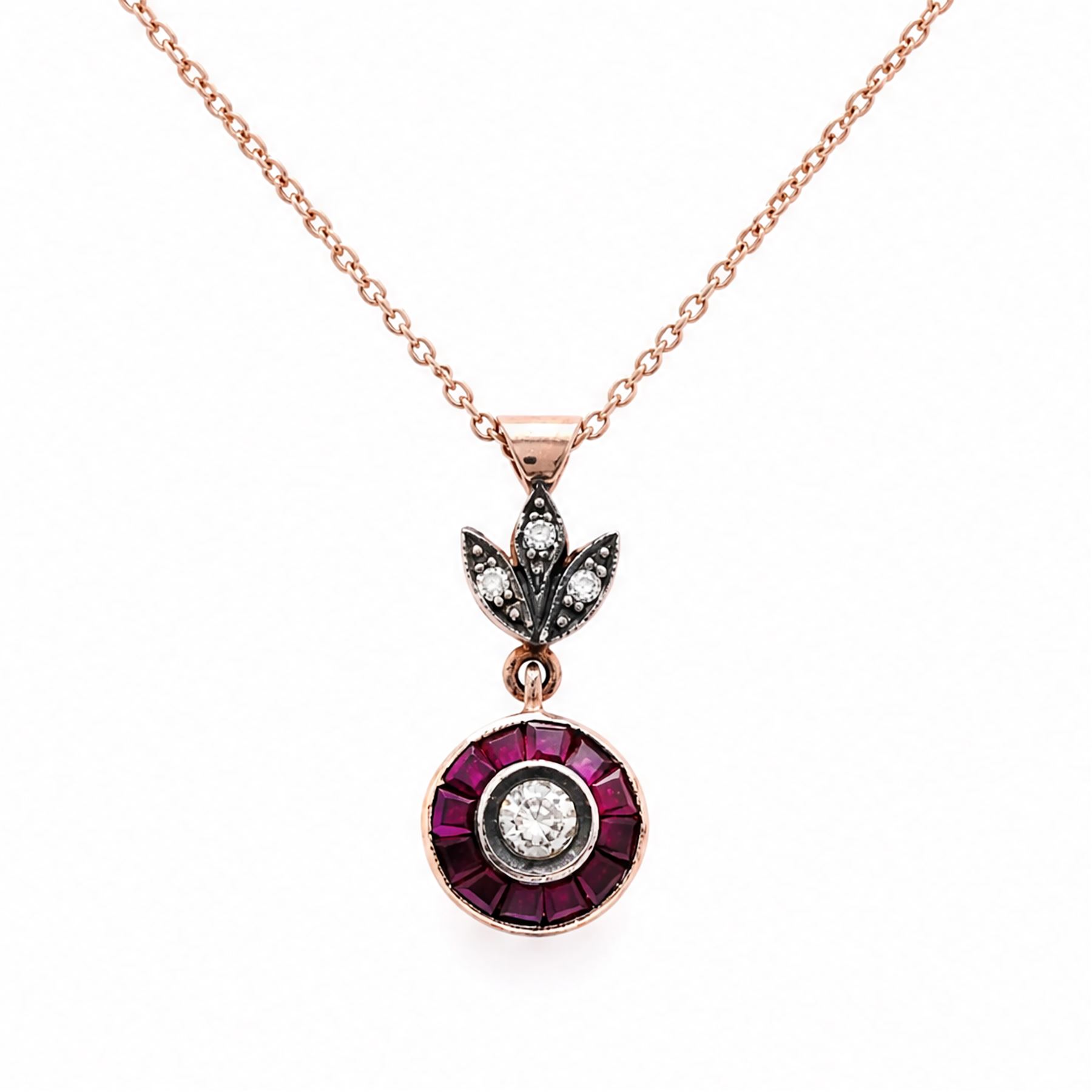 Gold and silver ruby and diamond pendant, single round brilliant cut diamond, surrounded by calibre cut rubies and round brilliant cut diamonds, suspending from a fancy pendant set with further diamonds, on a rose gold plated silver chain necklace, total diamond weight approx 0.30 carat, total ruby weight approx 0.30 carat