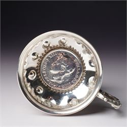 French silver tasse de vin with Minerva's head and makers mark J.P. with an anchor, the rim engraved C Mouly, Spanish tasse de vin inset with a silver coin and two other tasse de vin (4)