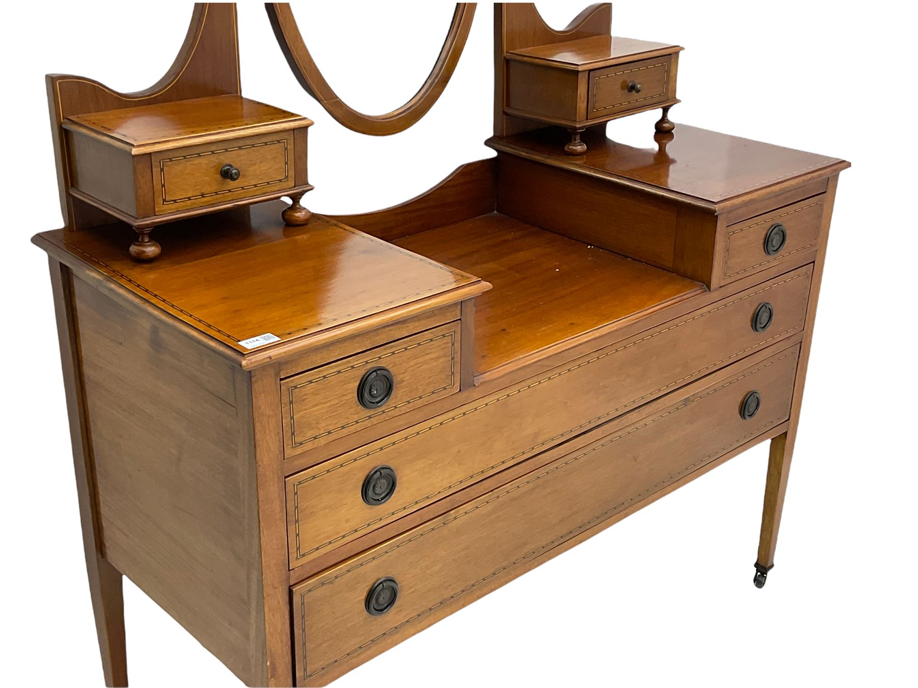 Edwardian inlaid mahogany dressing table, oval swing mirror, trinket drawers, above two small and two long drawers