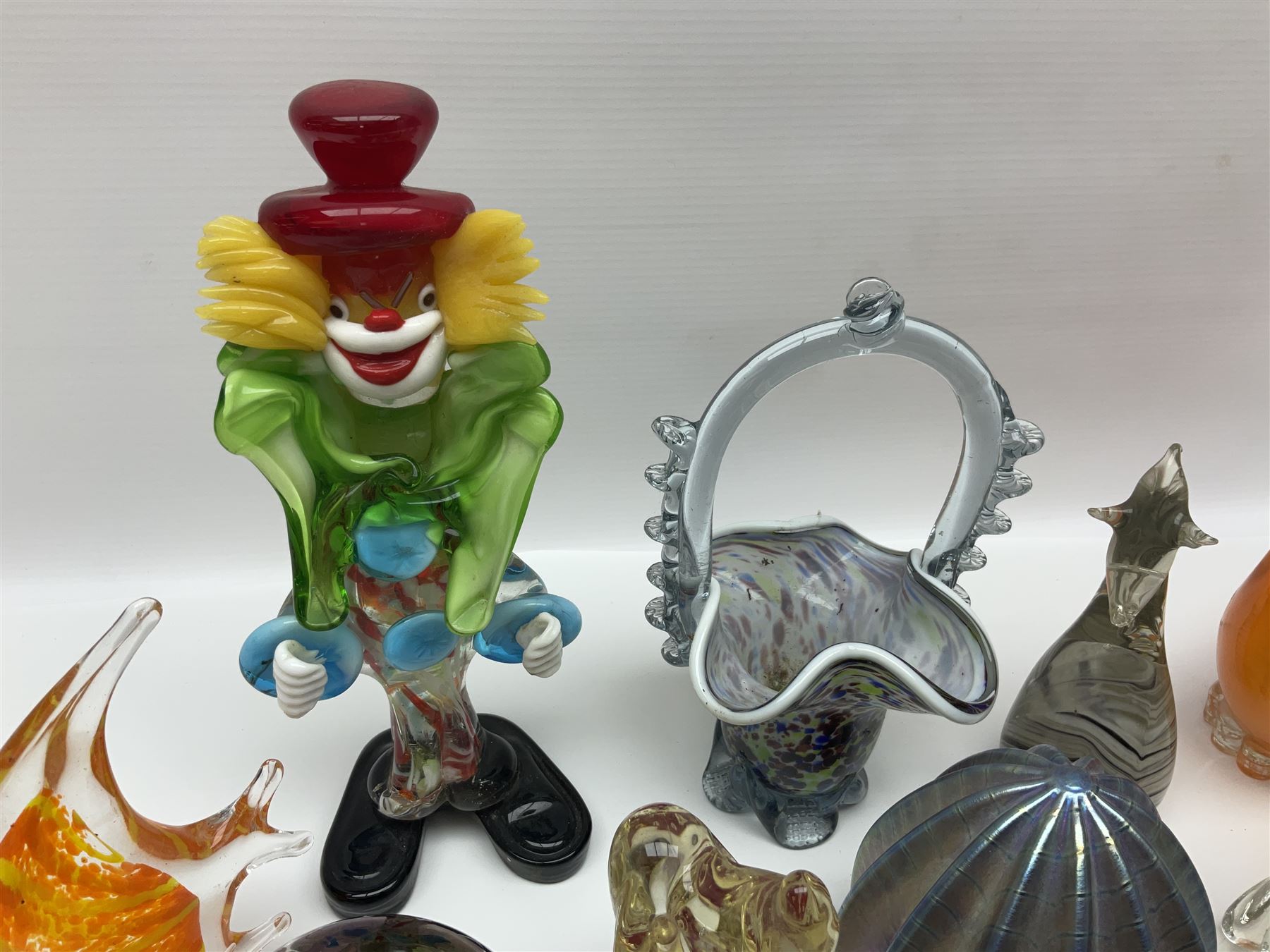 Robert Held iridescent art glass sea urchin paperweight, signed to underside, together with Murano glass clown and a collection of other glass paperweights and animals, etc 