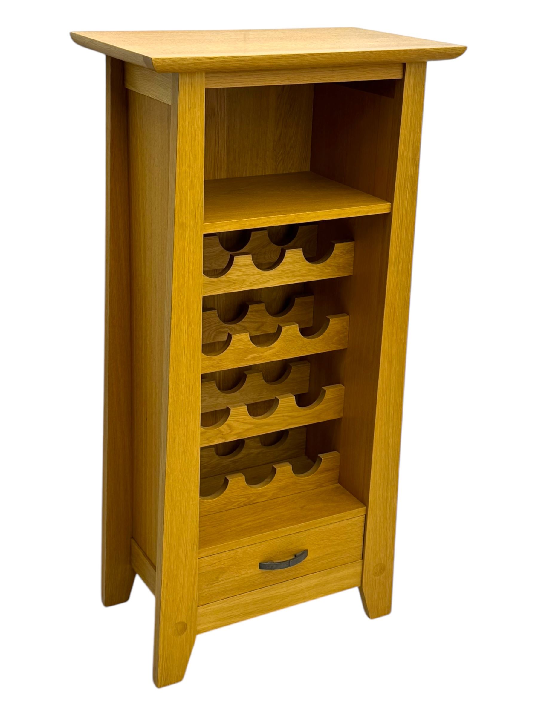 Contemporary light oak wine cabinet, rectangular overhanging top above an open shelf, fitted with four bottle racks each holding three bottles, single drawer with curved metal handle, on chamfered supports