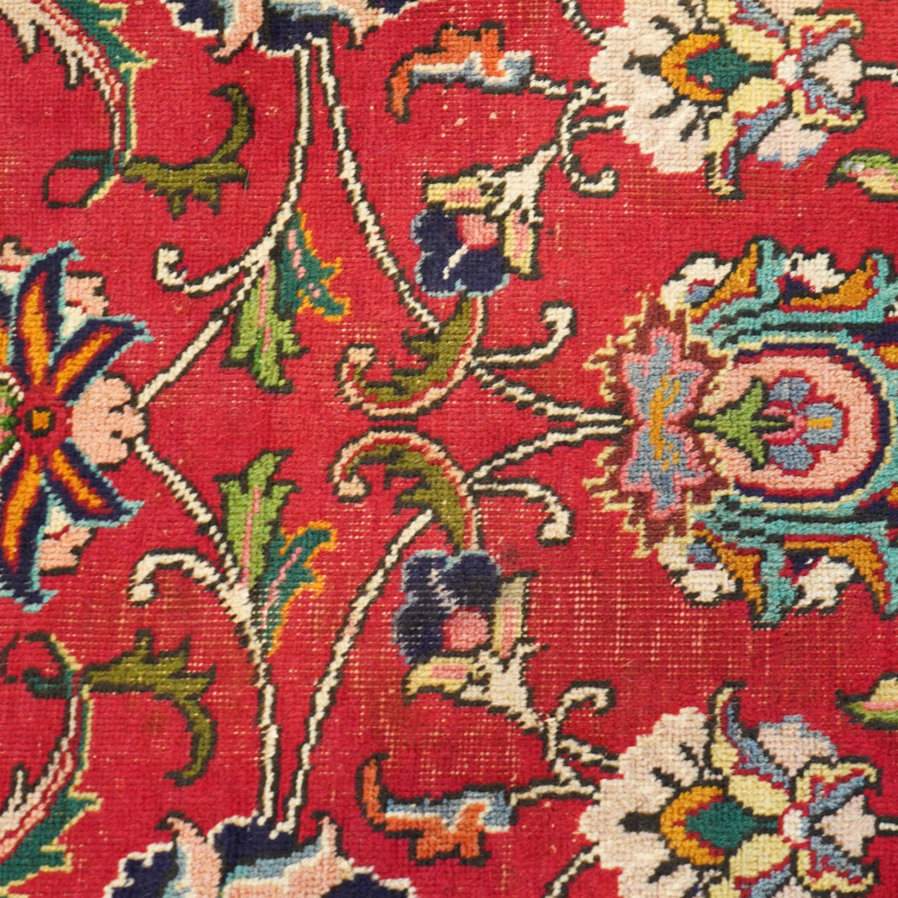 Persian Kashan carpet, red madder field, all over design of scrolling palmettes and flowering vines framed by an ivory border of lotus and arabesques between turquoise and red floral guards 294x387cm