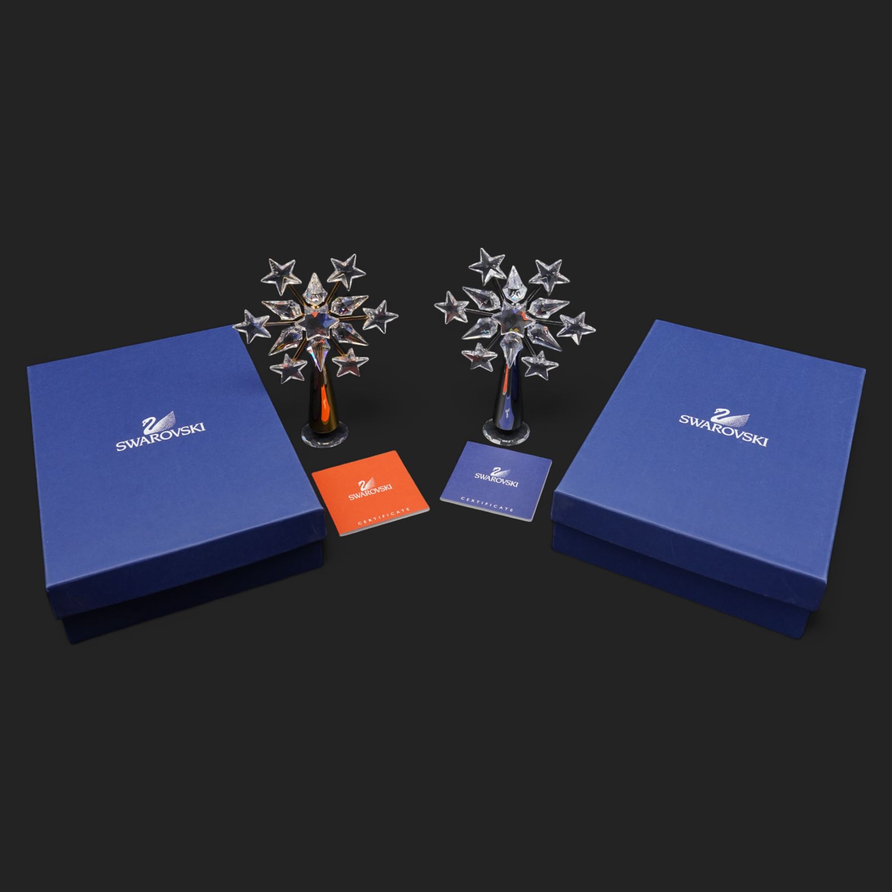 Two Swarovski crystal tree toppers, in gold and silver finishes, boxed (2)