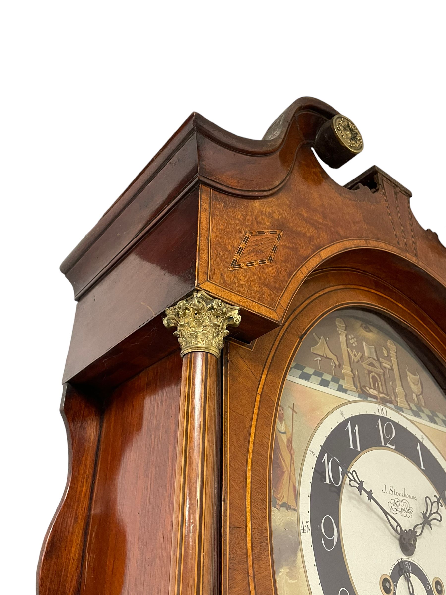 John Stonehouse of Leeds - mahogany 8-day longcase clock with a painted oval dial c1830, hood with a swans necked pediment and profuse contrasting inlay to both the hood and case, oval hood door with flanking pilasters and Corinthian capitals, conforming case with canted corners and short triple spire door, broad plinth with matching inlay and canted corners on shallow base, dial depicting masonic regalia, symbols, and pictorial depictions of the humanities, faith, hope, charity and righteousness, black chapter with white roman Arabic’s, date recorder and matching “crown” hands, dial pinned to a rack striking movement with a recoil anchor escapement, striking the hours on a coiled underslung gong. With weights and gridiron pendulum. 
This clock case is of large, impressive dimensions and was almost certainly commissioned for a large masonic lodge in Leeds, a rare and unique example.
