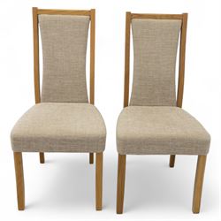 Ercol - light oak ‘Artisan’ rectangular dining table with chamfered top extending fold over top and tapered legs, together with two matching high back dining chairs upholstered in textured beige fabric (Chairs H 98cm, W 47cm, D 52cm)