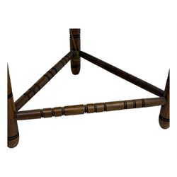 19th century swedish monk's chair, the oak frame with triangular seat and sloped arms, the backrest carved with geometric chipwork and a central pierced medallion 