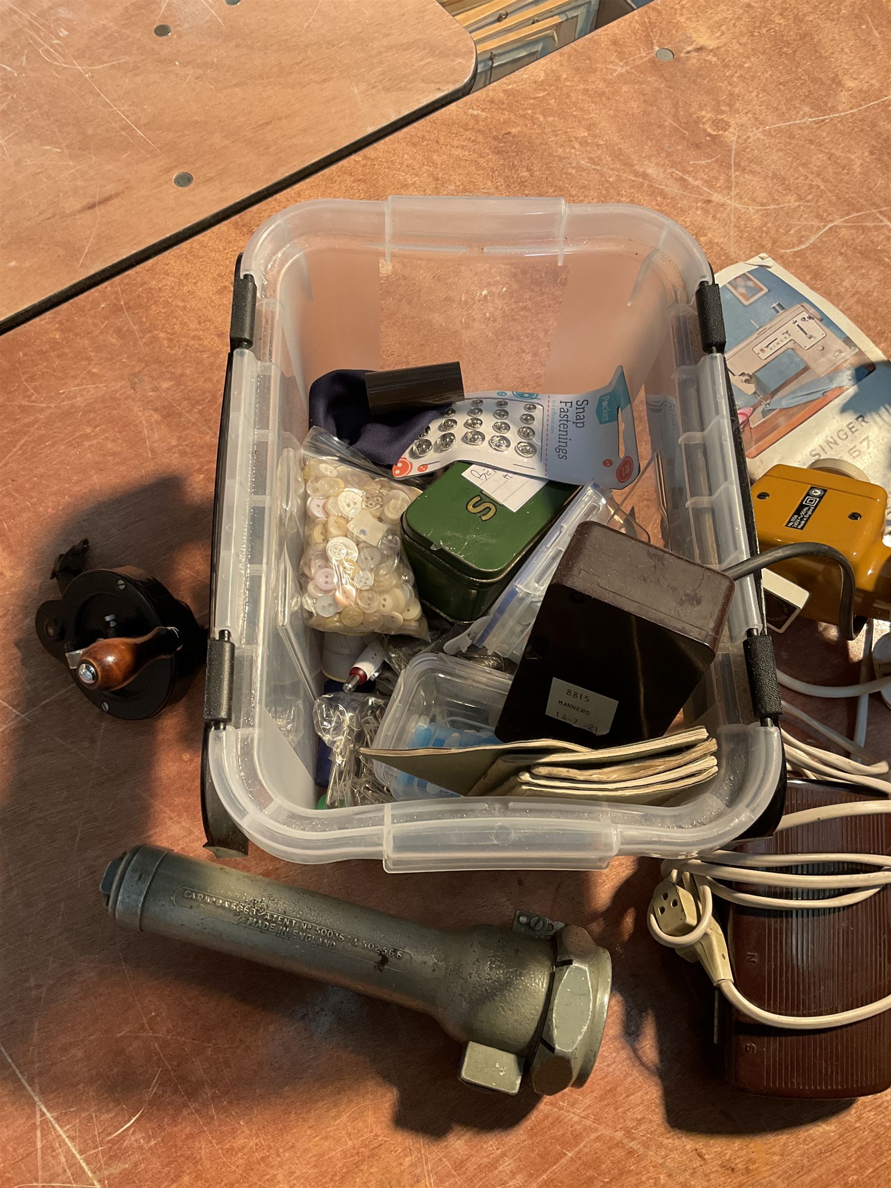 Two Singer sewing machines, model numbers 527 and 457, together with various Singer sewing machine parts, and a selection of sewing related accessories, to include threads, sewing needles, etc.