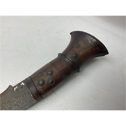 Kukri with 35.5cm engraved curving blade, steel mounted studded hardwood grip and engraved flat butt plate L46cm overall (no scabbard); and a Burmese Dha with 56.5cm slightly curving blade and copper mounted hardwood grip; in wooden scabbard L80cm overall (2)