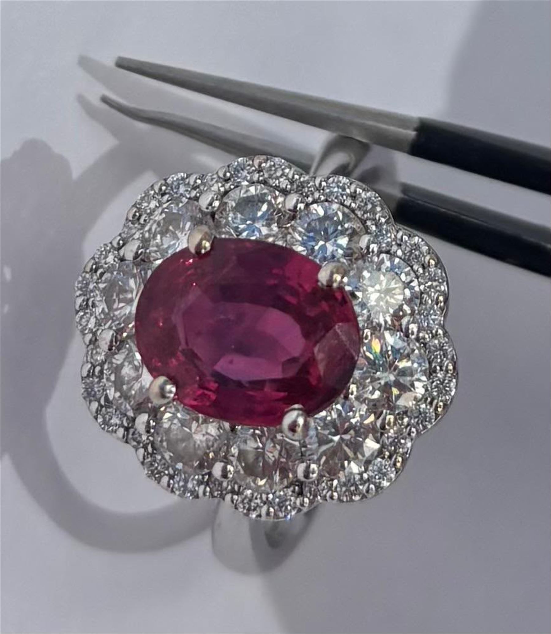 18ct white gold unheated oval ruby and round brilliant cut diamond cluster ring, hallmarked, ruby 3.07 carat, total diamond weight approx 1.65 carat, with WGI certificate